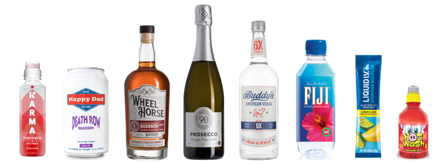 Eight assorted beverage bottles, cans, and packets are lined up, including water, vodka, bourbon, prosecco, hard seltzer, flavored drink mix, and a small colorful bottle of liquid. Labels are visible on each item.